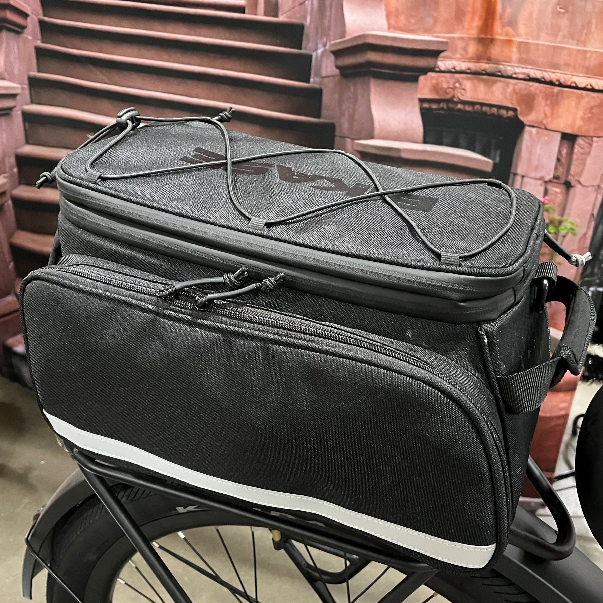 Big Poppa rack bag carried with the included shoulder strap